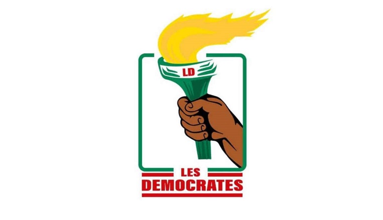 Une main tenant une torche avec la mention LD et le texte LES DEMOCRATES en dessous