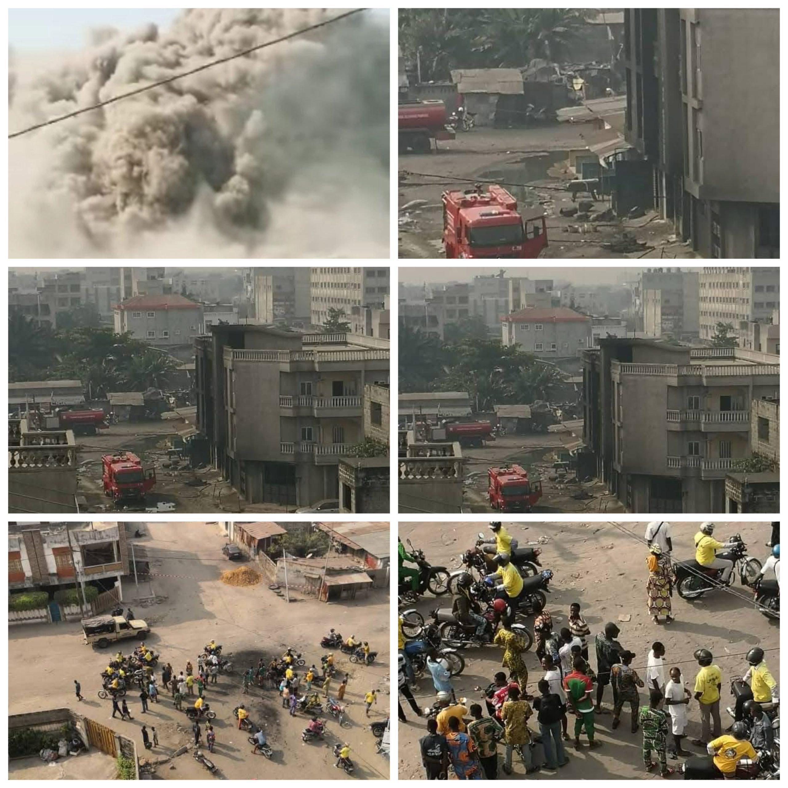 Fumée épaisse, camion de pompiers et foule rassemblée dans une zone urbaine après un incendie important