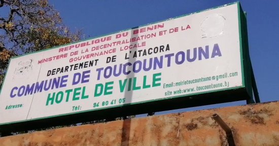 Panneau indiquant le nom de la commune, l'hôtel de ville, et des contacts téléphoniques et emails sur un mur extérieur